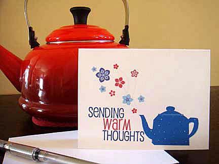 Sending Warm Thoughts greeting card with a blue teapot beside a red kettle