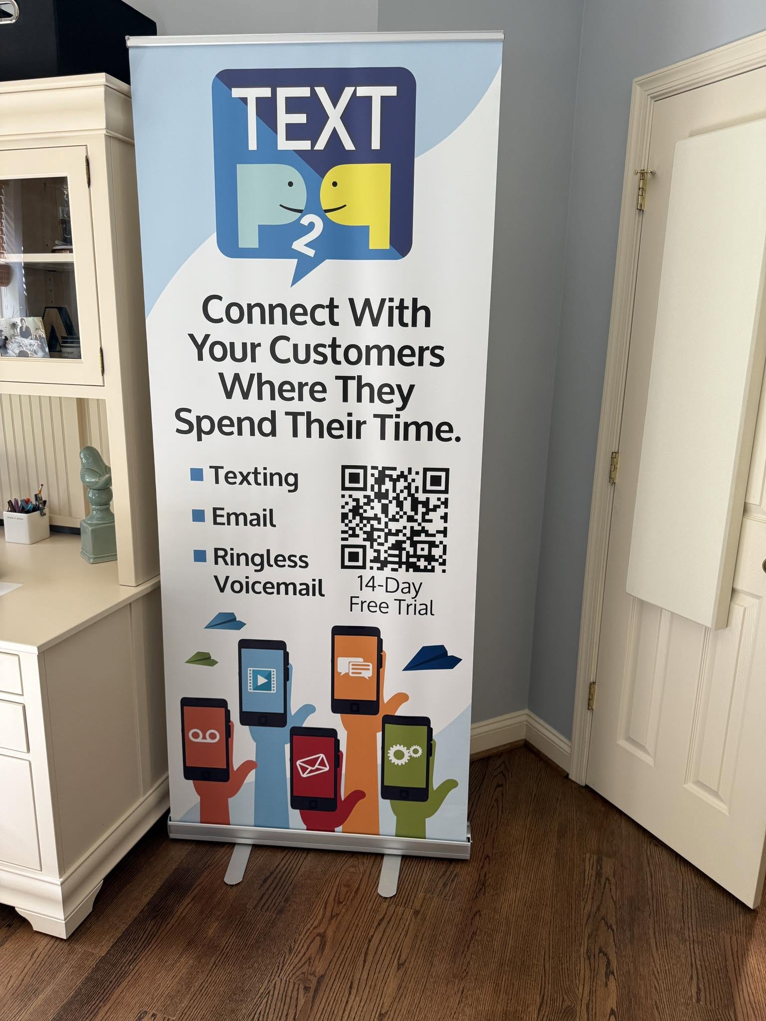 TextP2P retractable marketing banner with colorful graphics and customer communication services
